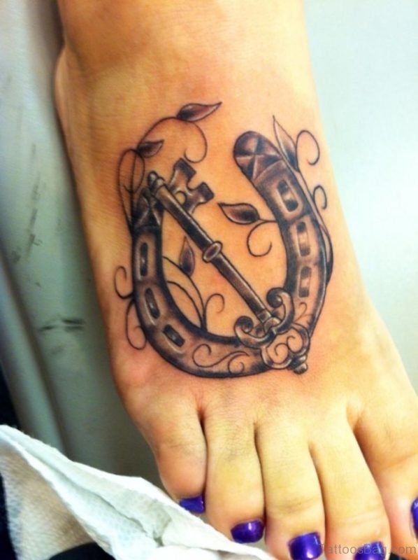 Key Horseshoe Tattoo On Right Foot For Girls