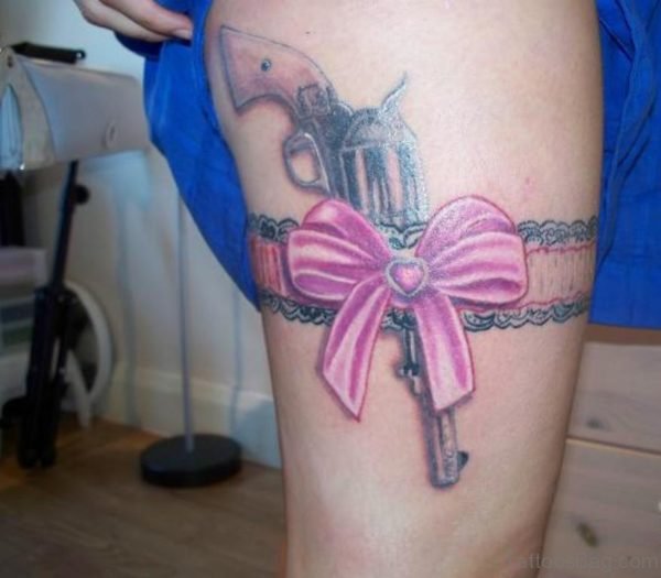 Pink Bow And Gun Tattoo