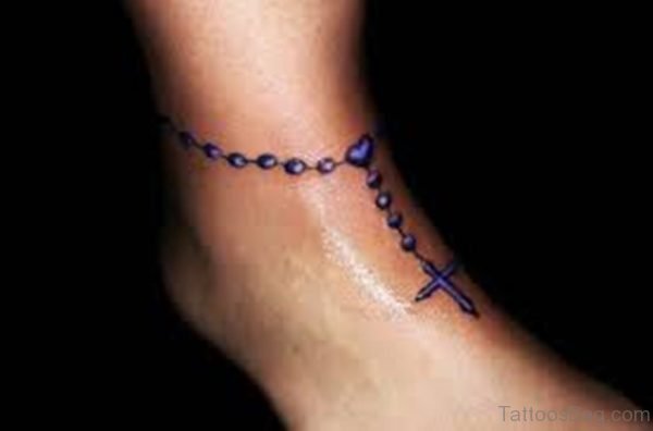 Purple Ink Cross Rosary Tattoo On Ankle