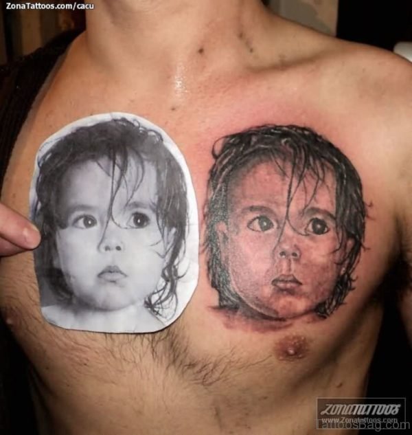 Realistic Baby Face Portrait Tattoo On Man Chest 