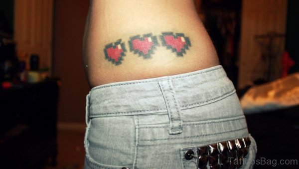 Red Ink Heart Tattoo On Waist