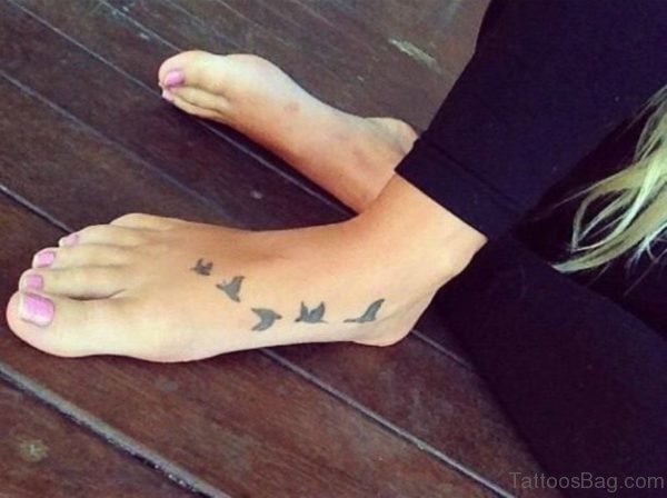 Simple Flying Bird Tattoo On Foot