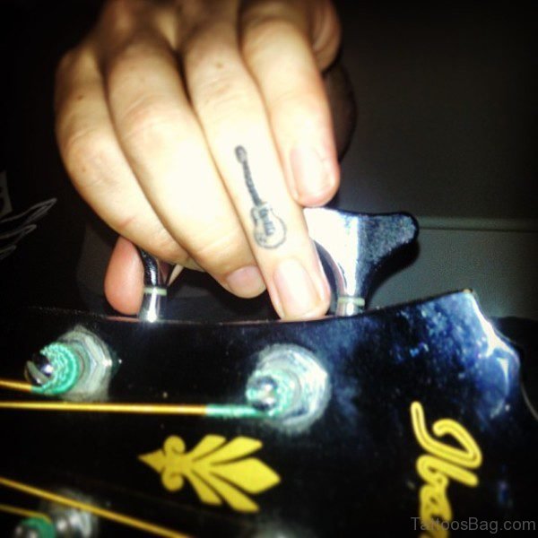 Tiny Guitar Tattoo On Finger