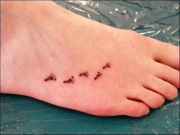 Amazing Black Little Footprints Tattoo