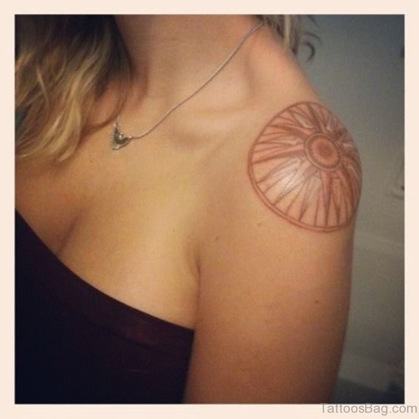 Brown Circle Tattoo On Shoulder