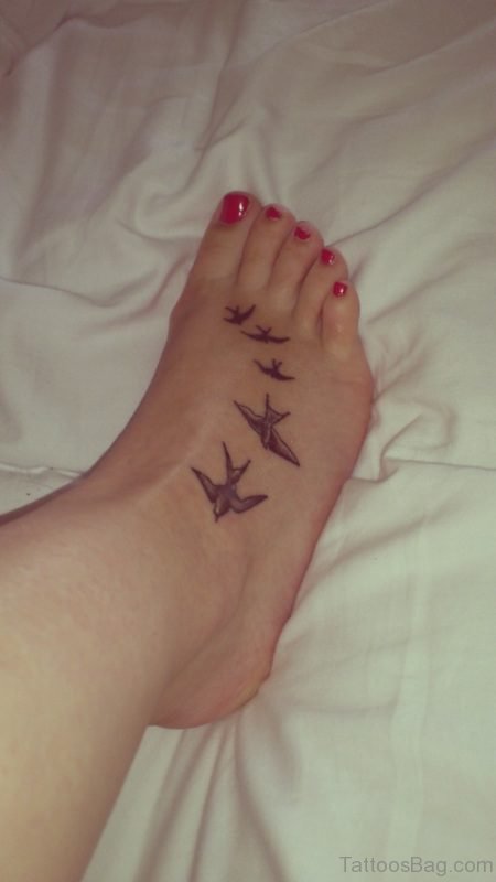 Flying Brown Bird Tattoo On Foot