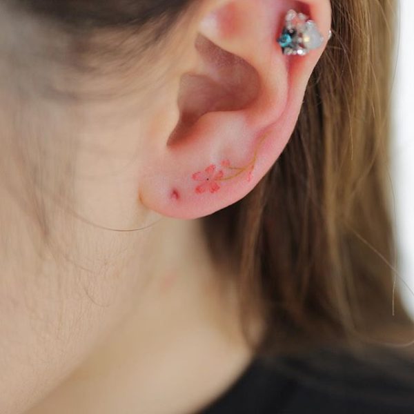 Tiny Flower Tattoo On The Ear