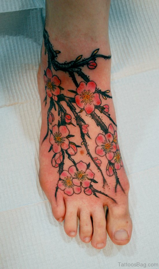 cherry blossom and butterfly foot tattoo